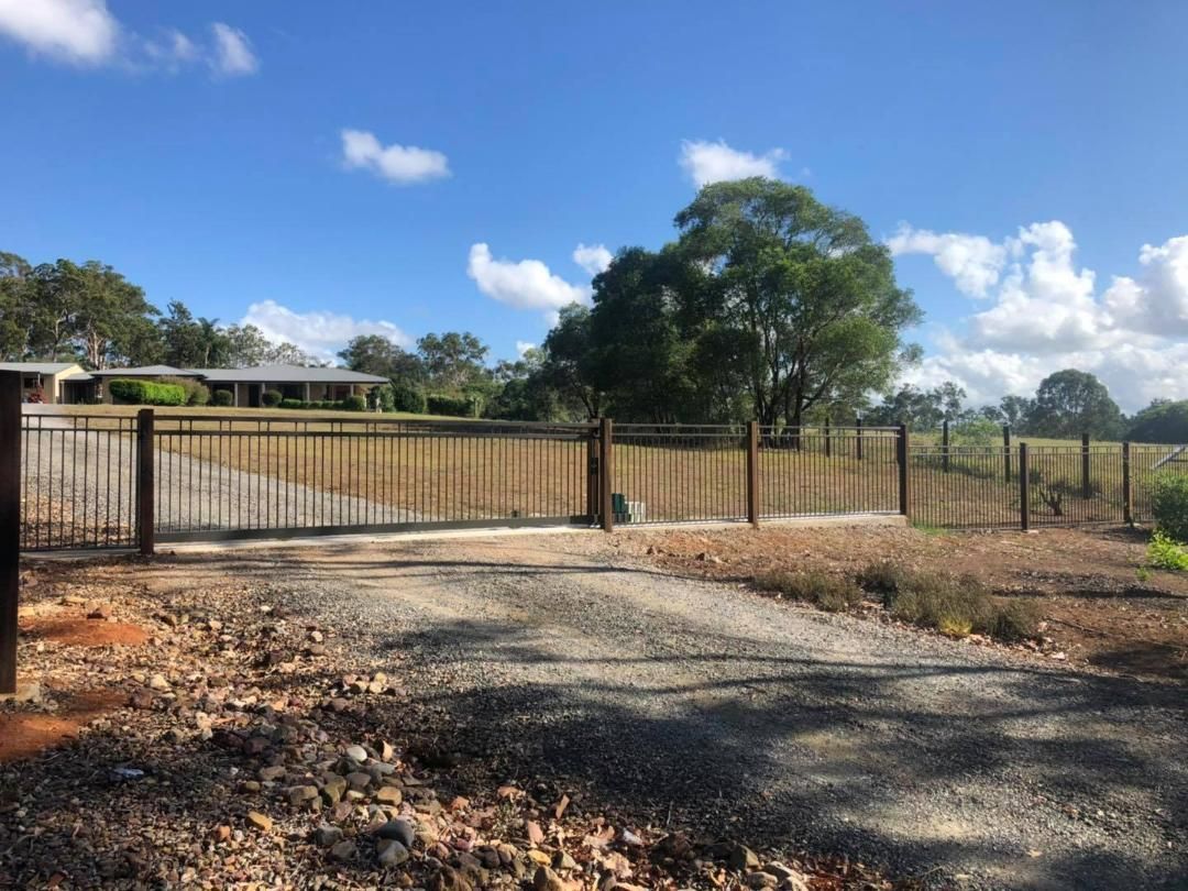 Driveway With a Fence and a House in the Background — Lange's Fencing and Landscaping Centre in Hervey Bay, QLD