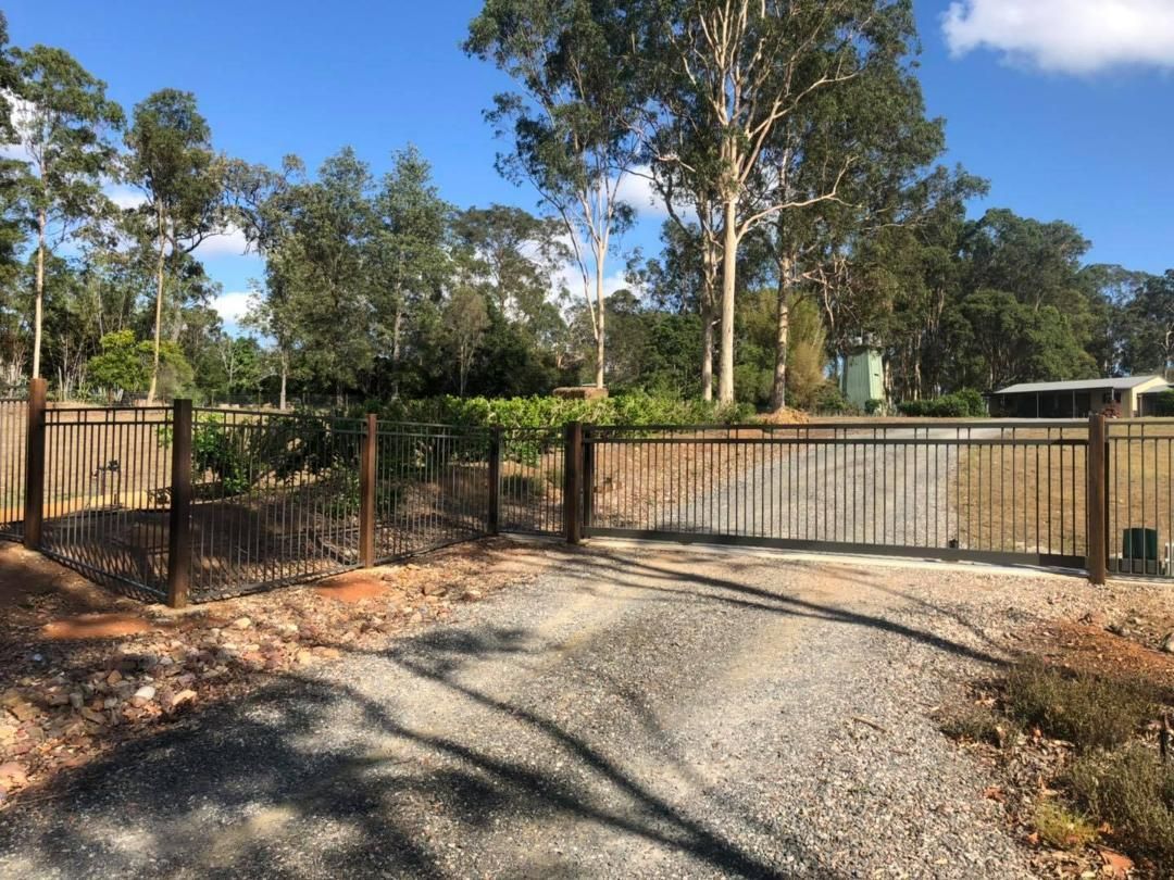 Gravel Driveway Leading to a Fence With Trees in the Background — Lange's Fencing and Landscaping Centre in Island Plantation, QLD