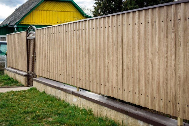 Wooden Fence With a Gate in Front of a House — Lange's Fencing and Landscaping Centre in Gympie, QLD