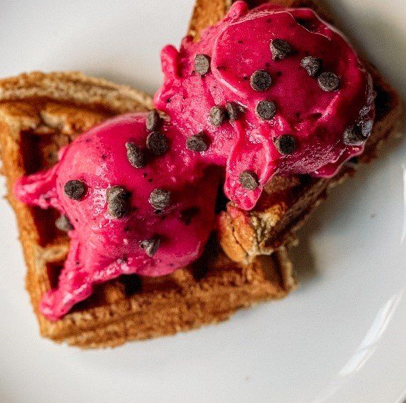 Waffles topped with dragon fruit nice cream with chocolate chips