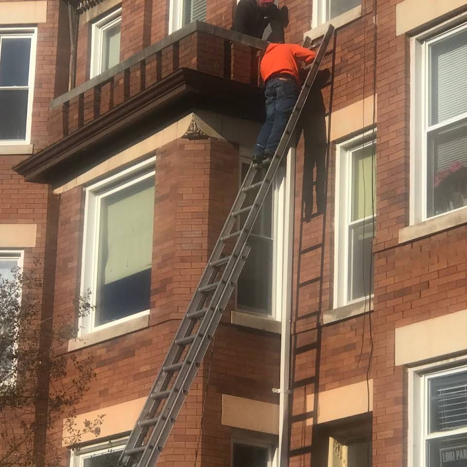 Man Working On A Brick Building — Washington, D.C — John's Home Improvement