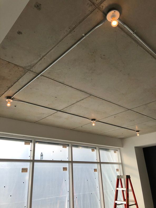 Une pièce avec une échelle et une lumière au plafond