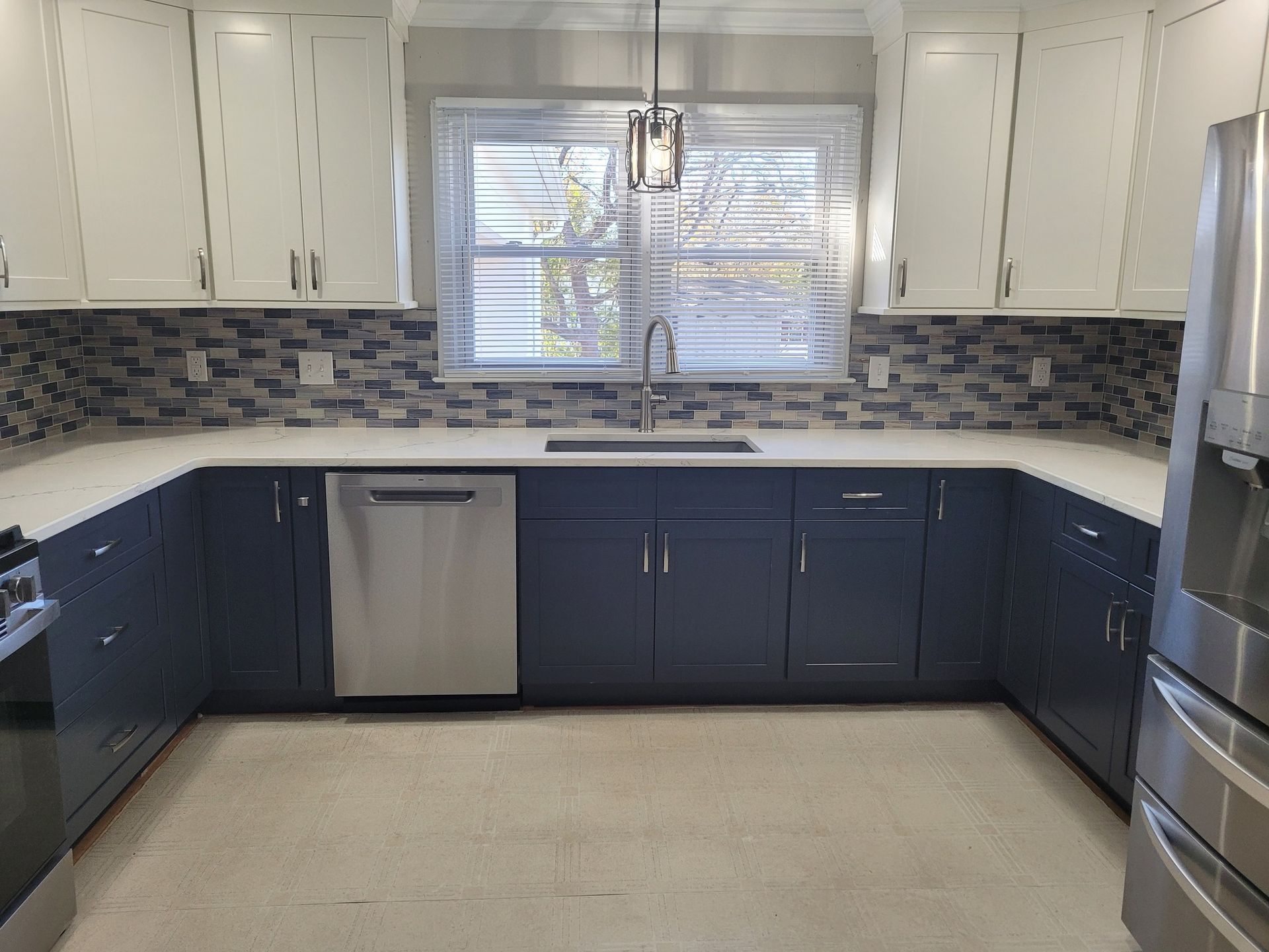 U-shaped kitchen with white upper cabinets.