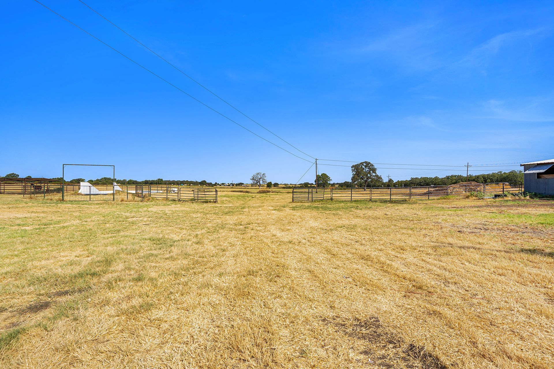 A large empty field with a blue sky in the background.