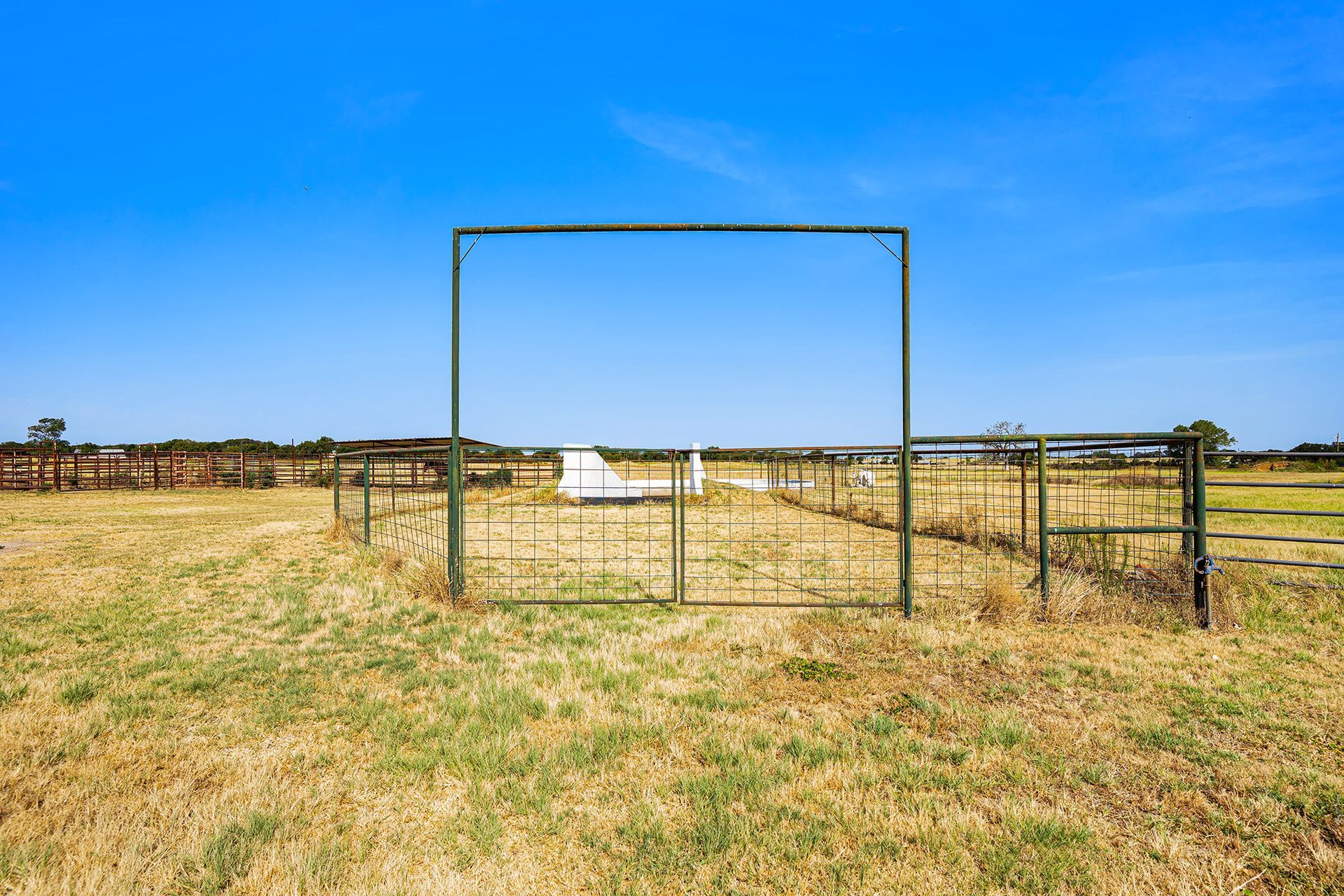 There is a soccer goal in the middle of a field.