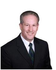 A man in a suit and tie is smiling for the camera.