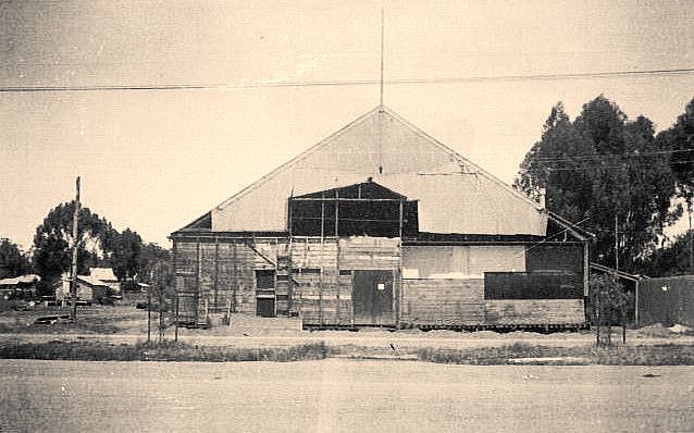 A black and white photo of a building under construction
