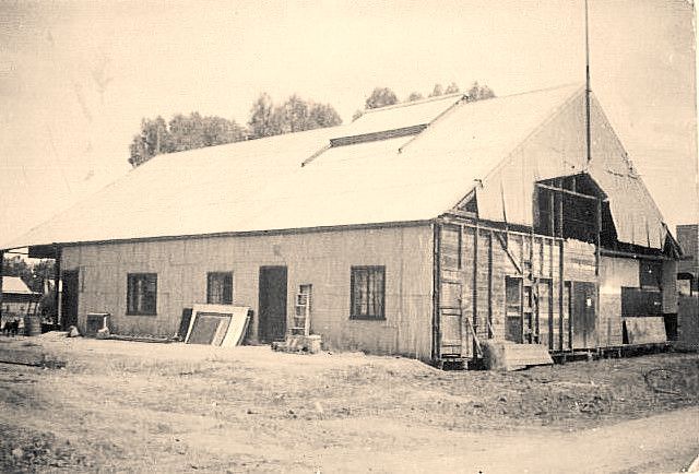 A black and white photo of a building under construction