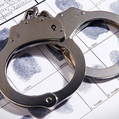 Criminal Law — Handcuffs placed on a Paper with Fingerprints in Savannah, GA Criminal Law — Handcuffs placed on a Paper with Fingerprints in Savannah, GA