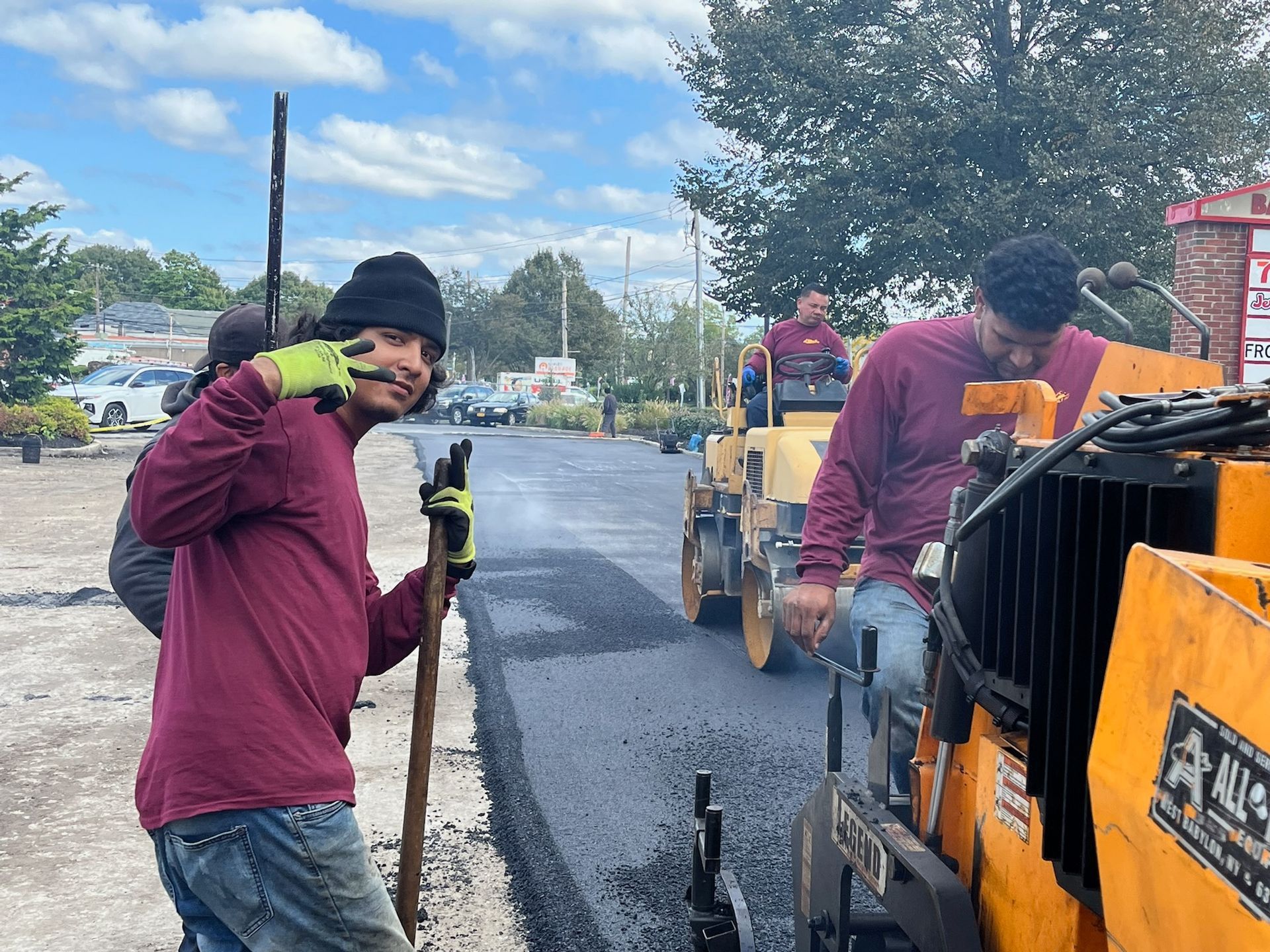 A car is parked on a brick driveway in front of a house.