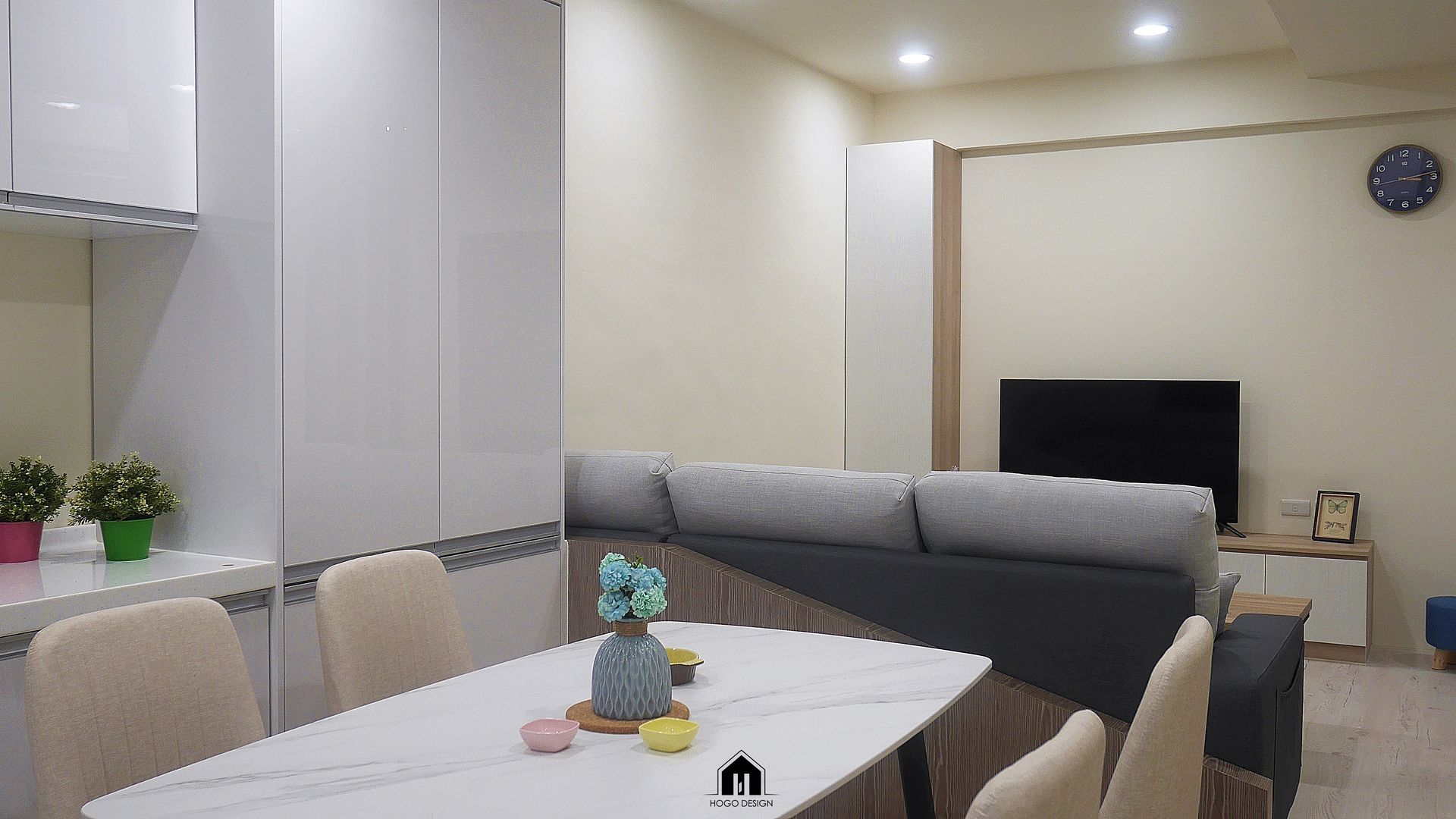 A living room with a dining table and chairs and a couch.