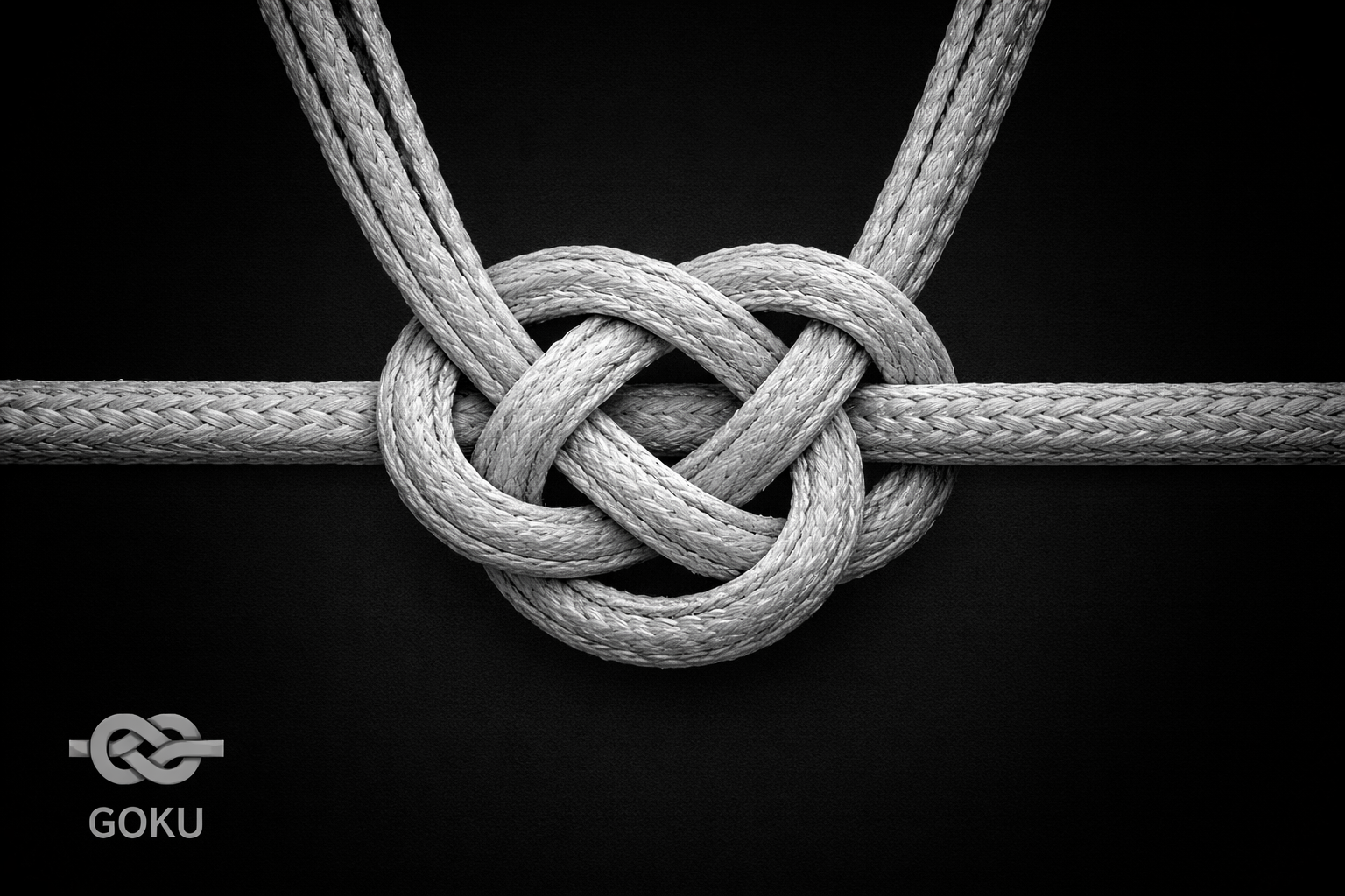 Close-up of a heart-shaped knot tied with three ropes against a black background.