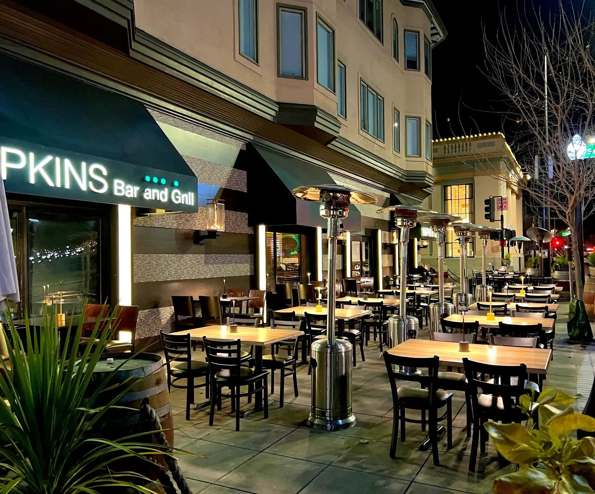 Living room with teal sectional sofa, fireplace, and two armchairs.