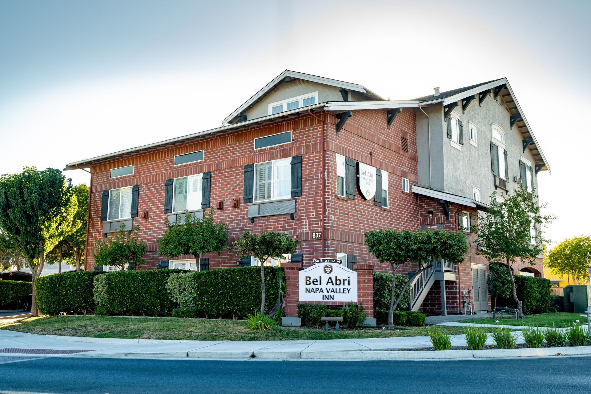 Bel Aires retirement home, Napa, California, brick building, sign, landscaping, blue sky.