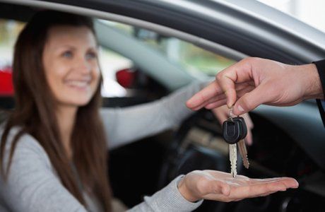 woman holding out her hand to receive car keys