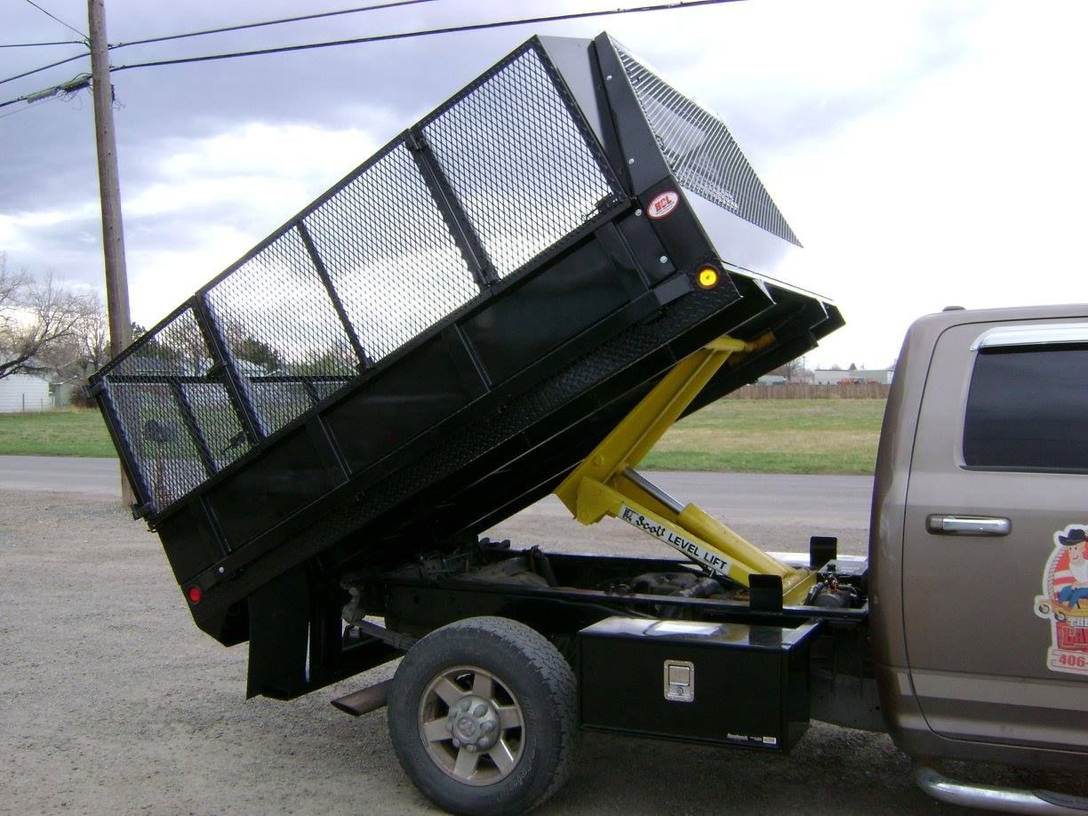 A Gray Truck with A Dump Bed Is Parked in A Parking Lot