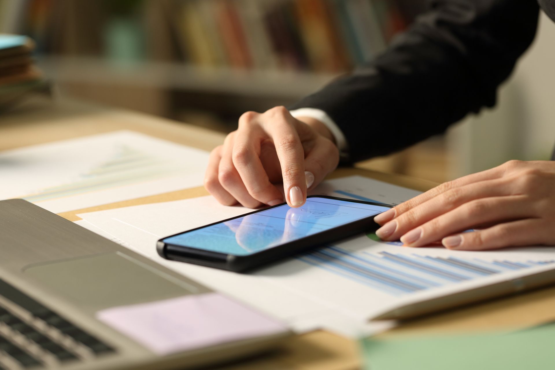 Close up of entrepreneur woman hands signing contract on smart phone with finger.