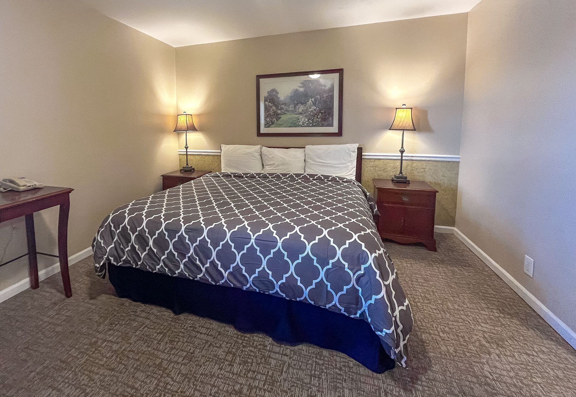 A bedroom with a large bed and a window.