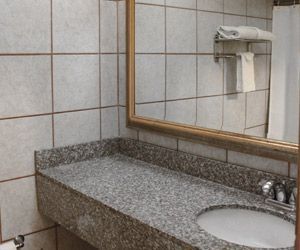 A bathroom with a sink and a mirror.