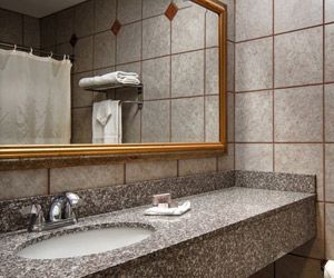 A bathroom with a sink and a large mirror.