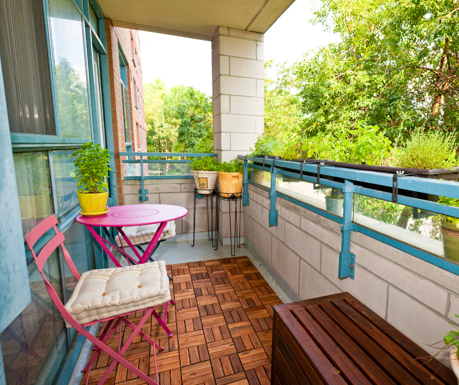A balcony with a table and chairs and potted plants