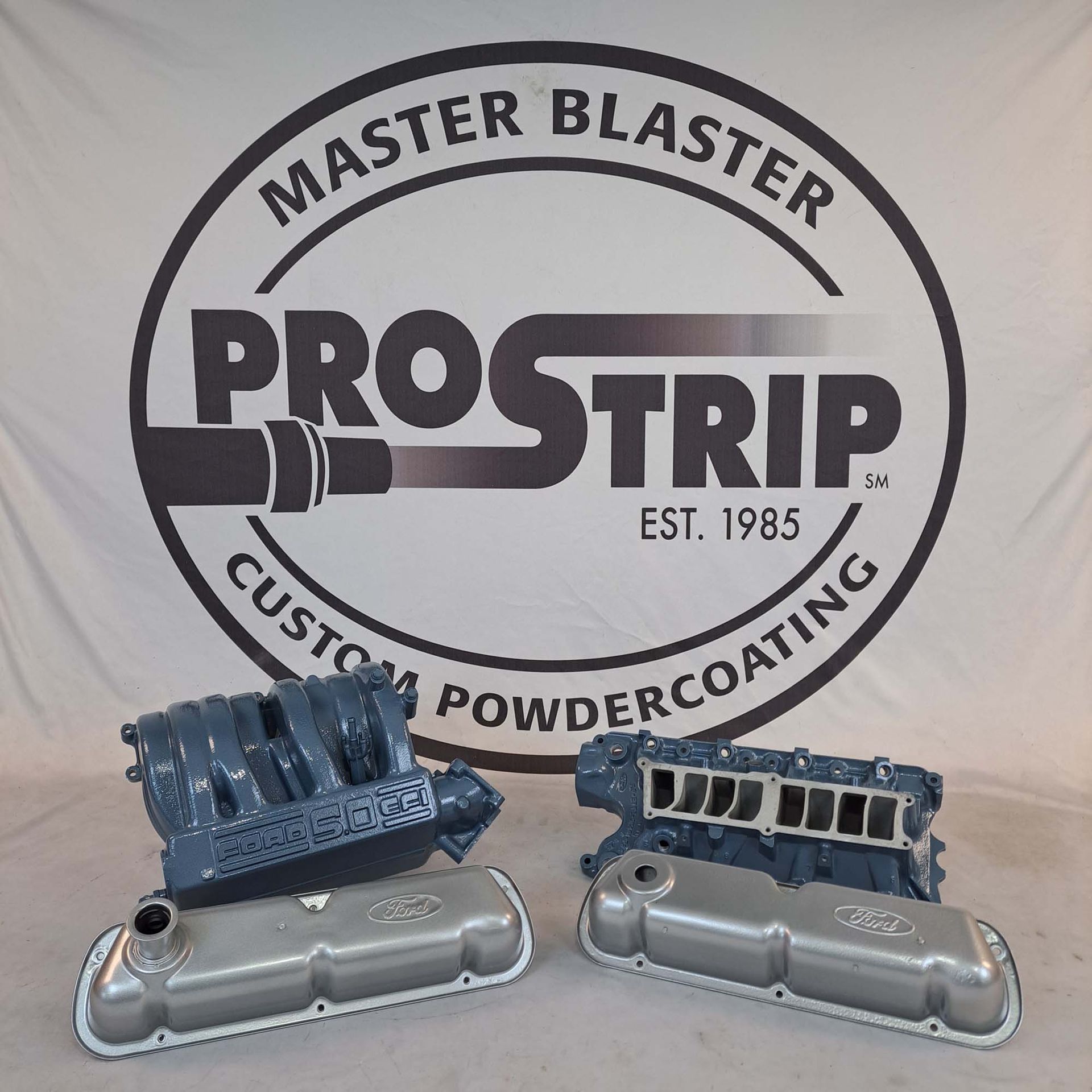Two engine covers are sitting in front of a master blaster logo