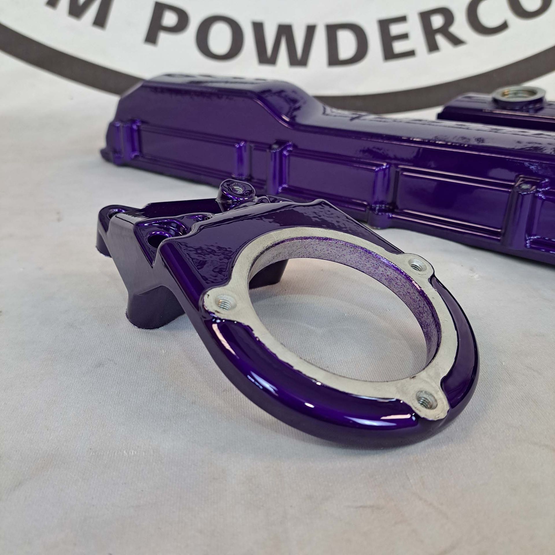 A purple object is sitting in front of a sign that says powderco