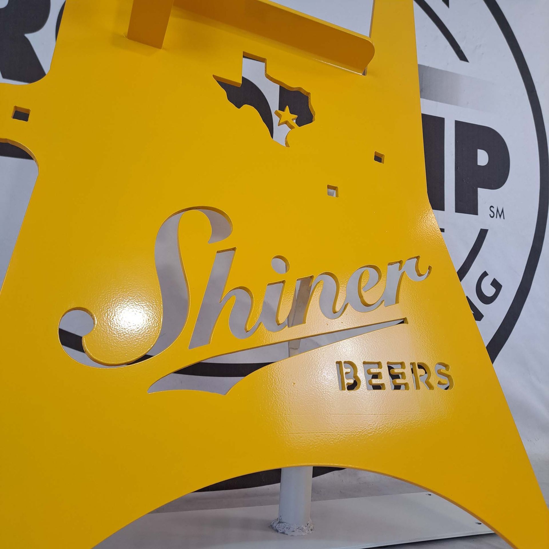 A yellow sign that says shiner beers on it