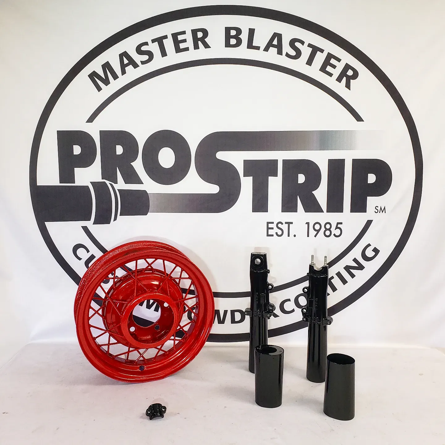 A master blaster logo with a red wheel in front of it