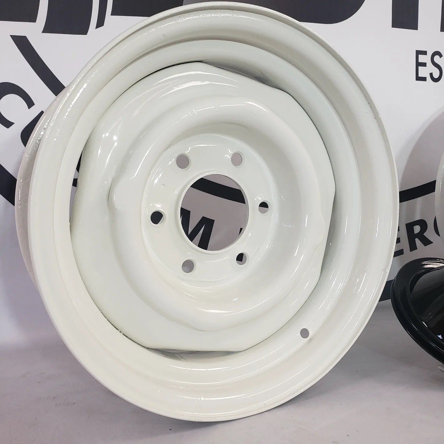 A close up of a white wheel with holes in it