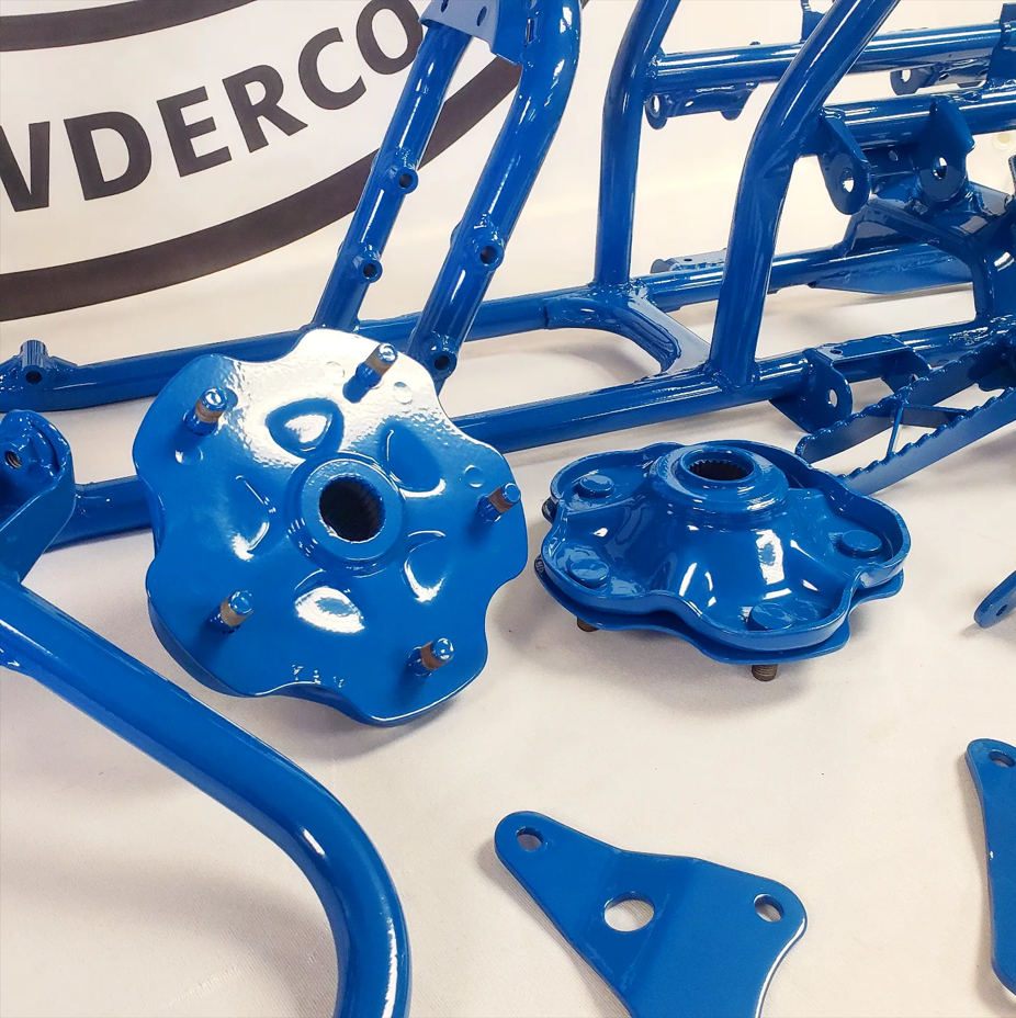 A bunch of blue parts are on a table with a sign that says vderco