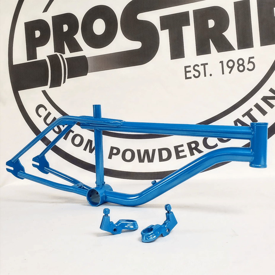 A blue bicycle frame is sitting in front of a prostrip logo