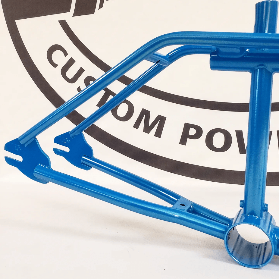 A blue bicycle frame is sitting in front of a custom power logo