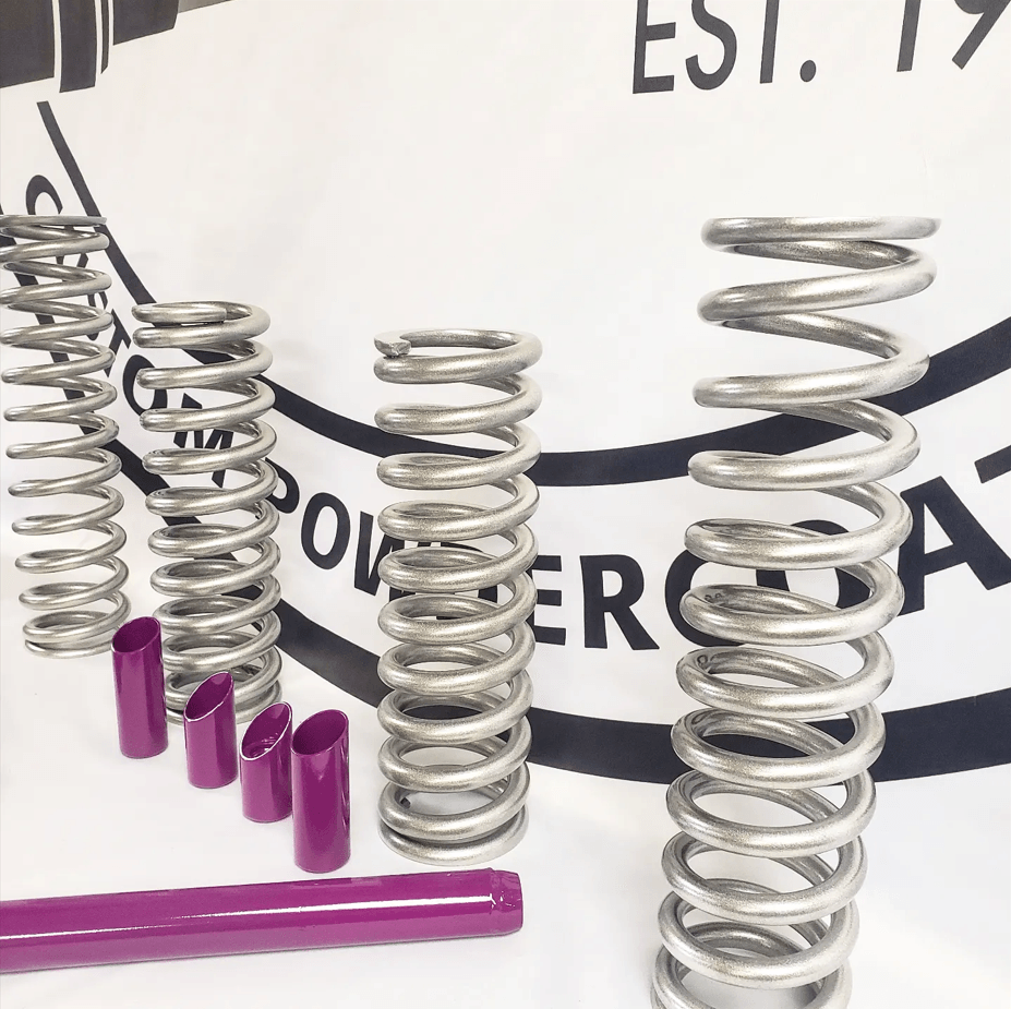 A bunch of stainless steel springs are sitting on a table