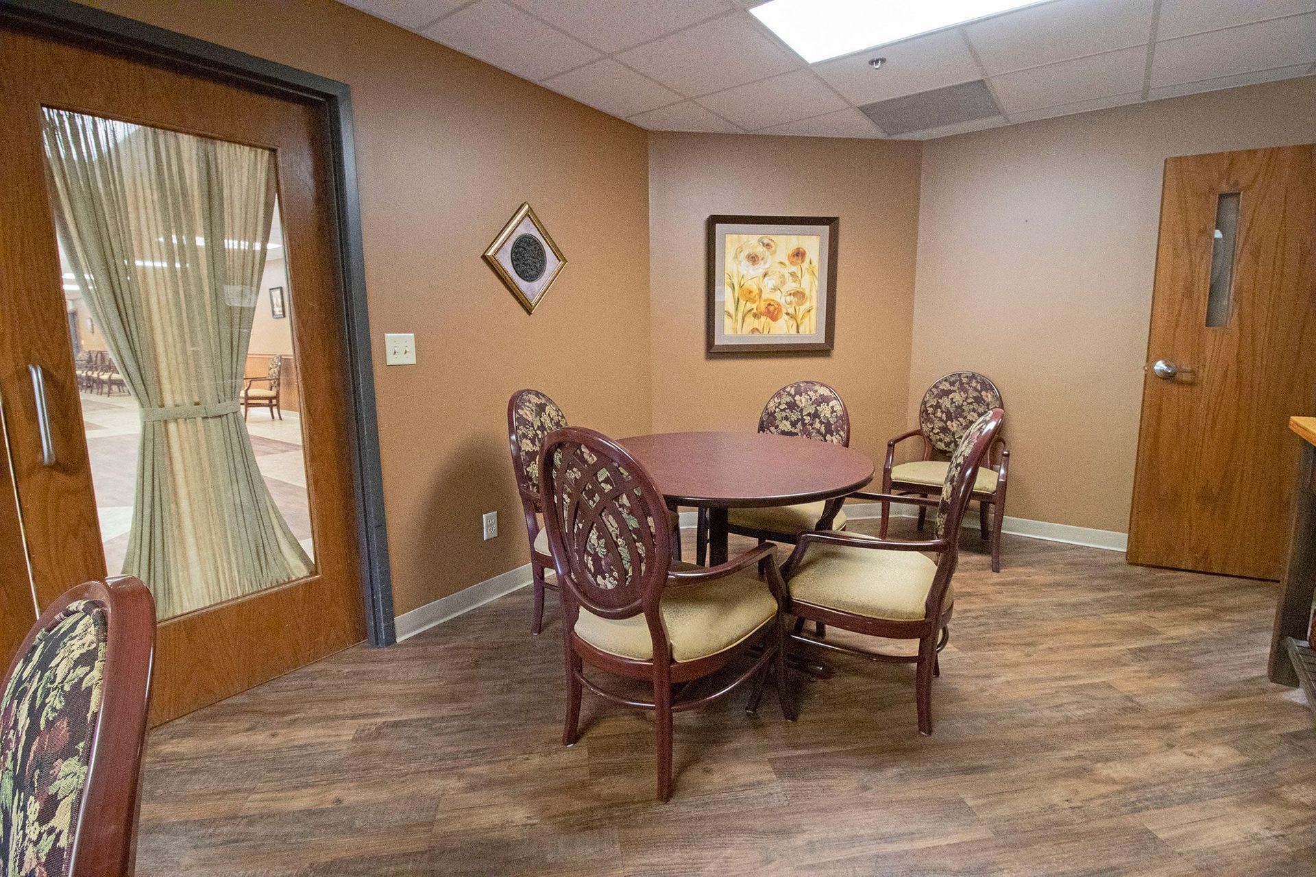 A room with a table and chairs in it