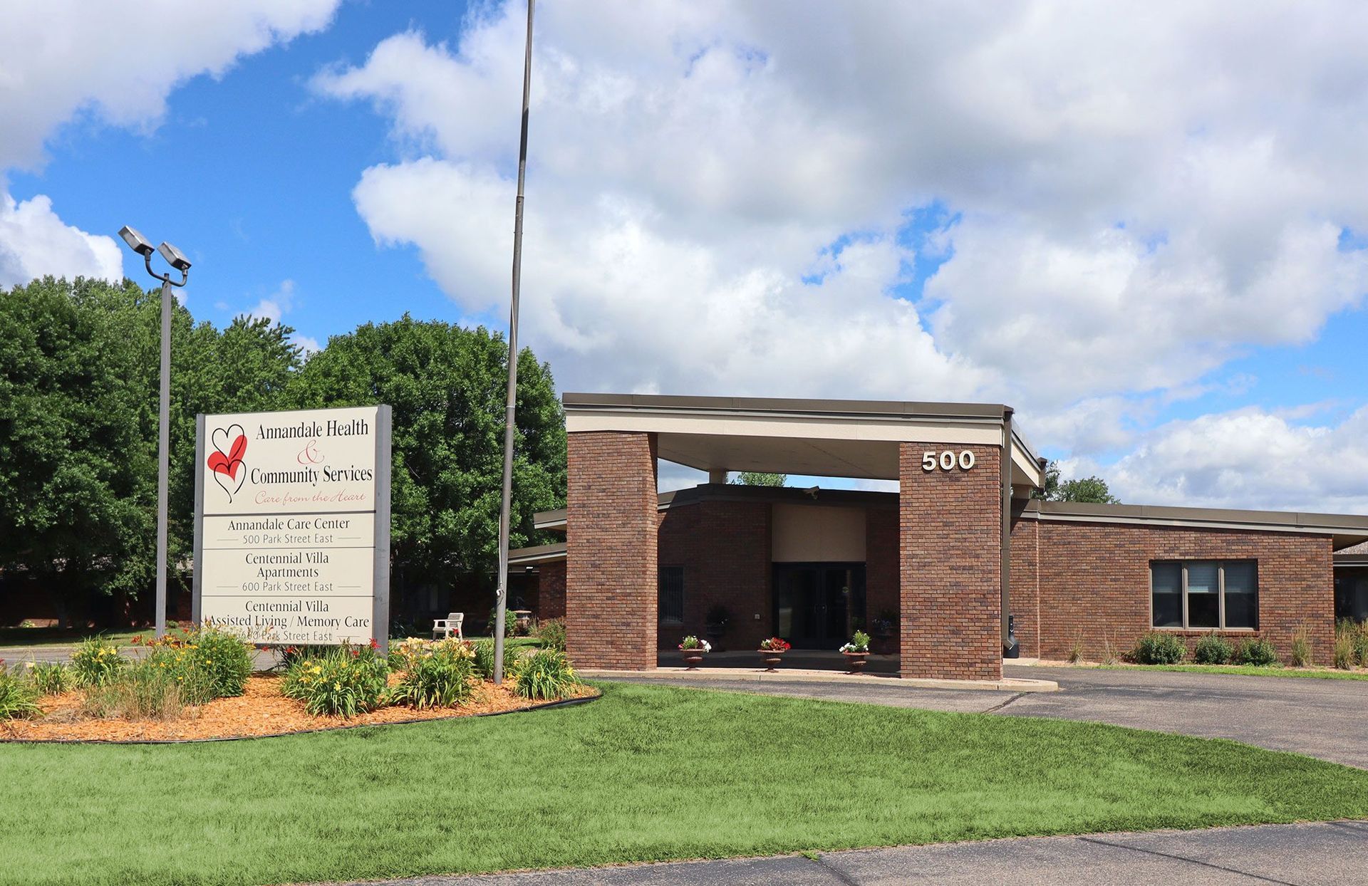 A large brick building with a sign in front of it A large brick building with a sign in front of it