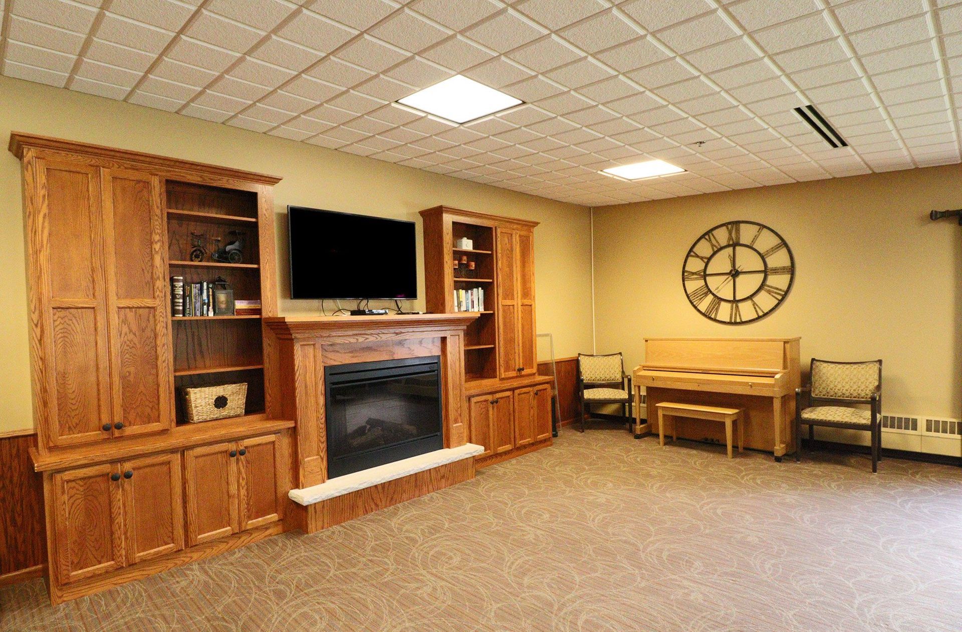 A living room with a fireplace , television , and piano.
