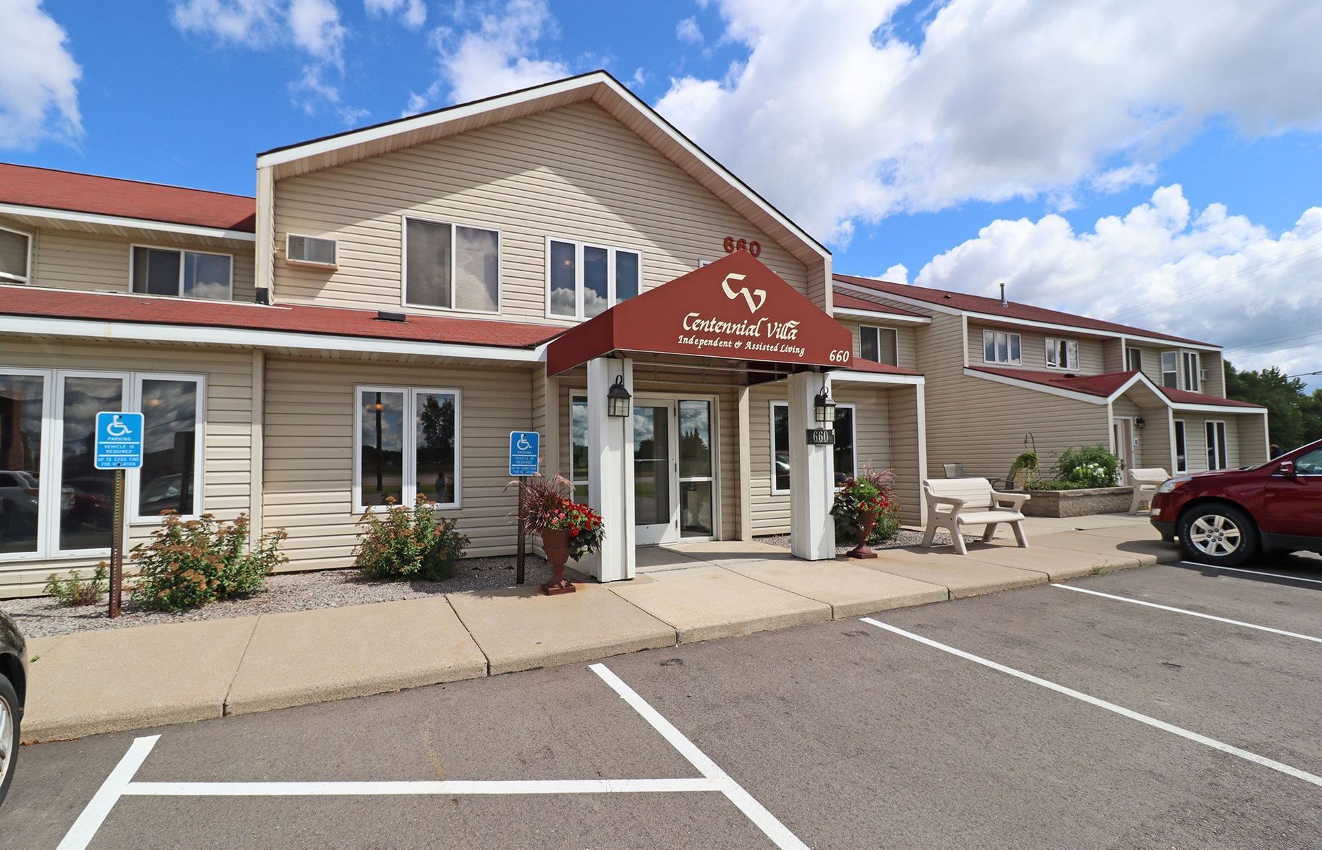 A large building with a parking lot in front of it A large building with a parking lot in front of it