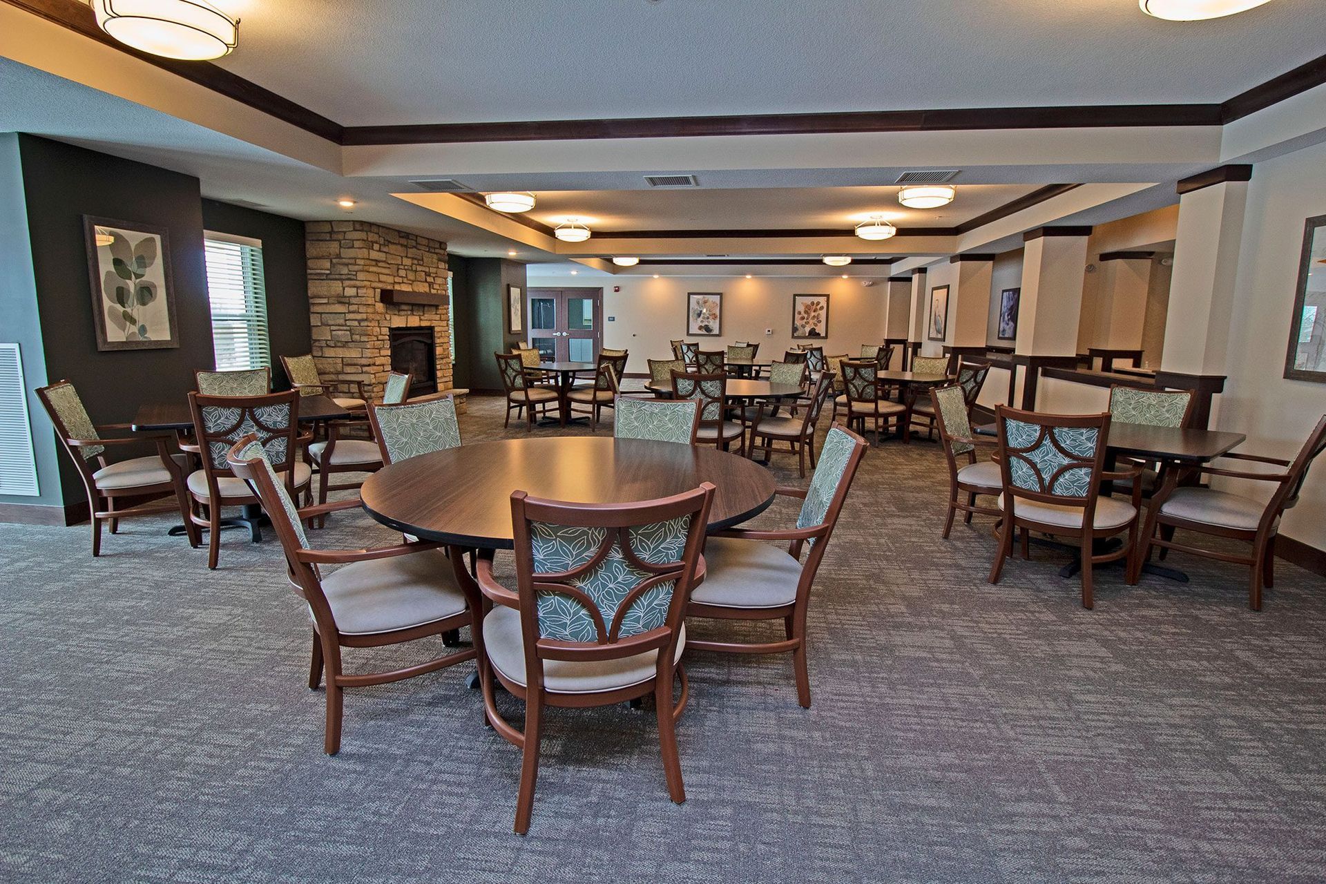 A large room with tables and chairs in it