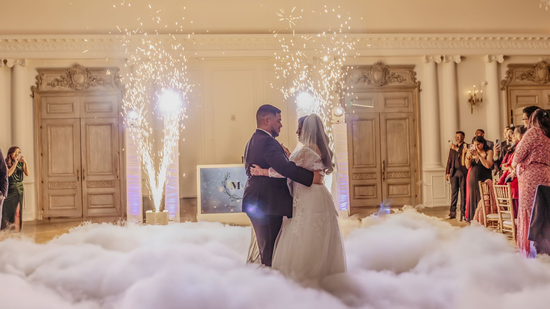A bride and groom are dancing in the clouds at their wedding reception.