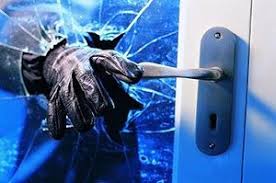 A glove is breaking through a glass door.
