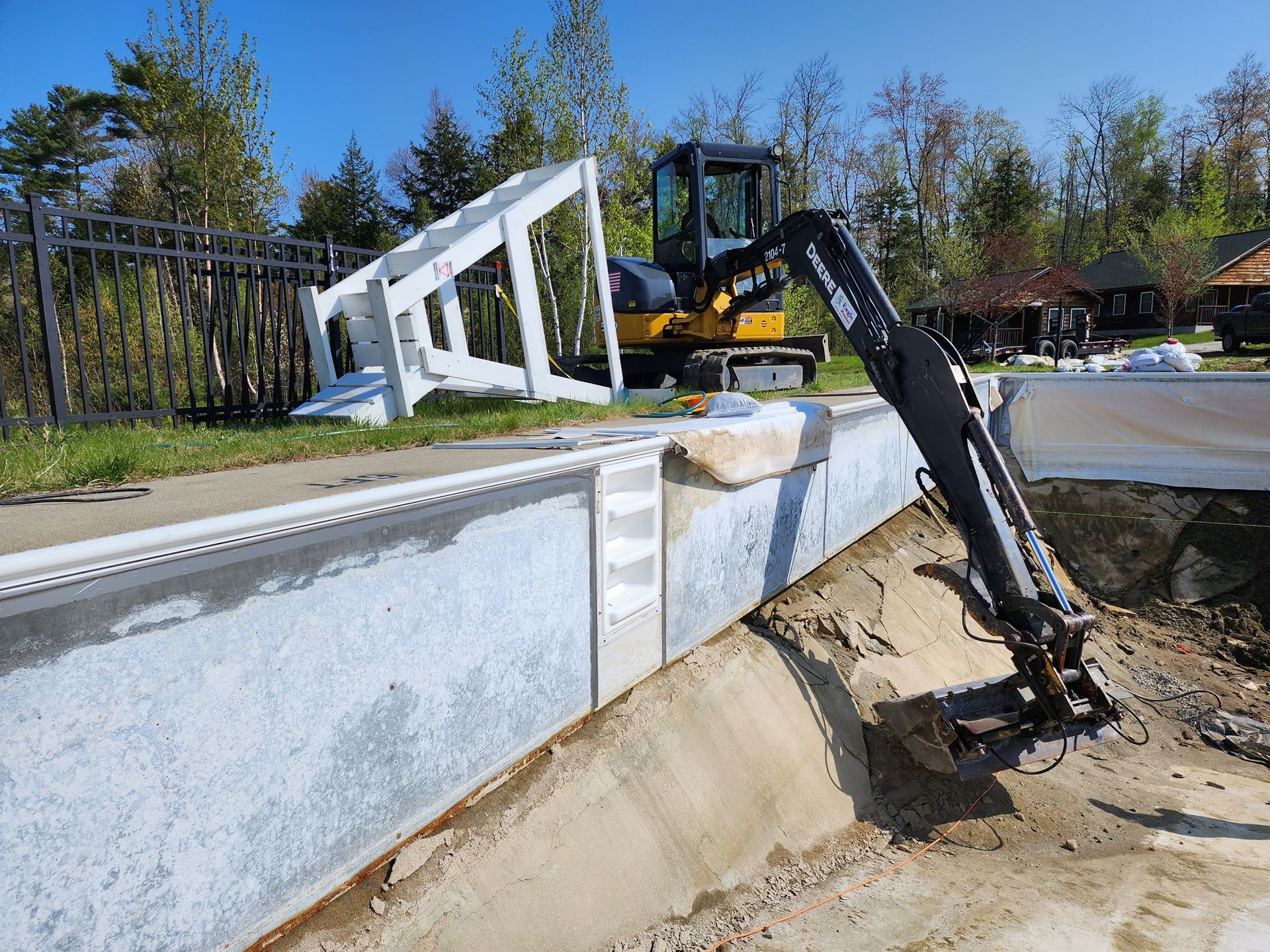 A bulldozer is digging a hole in the ground to build a swimming pool.
