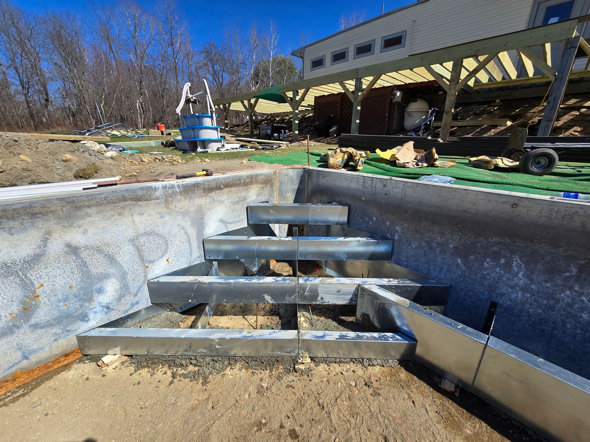 A metal staircase is being built into a swimming pool.