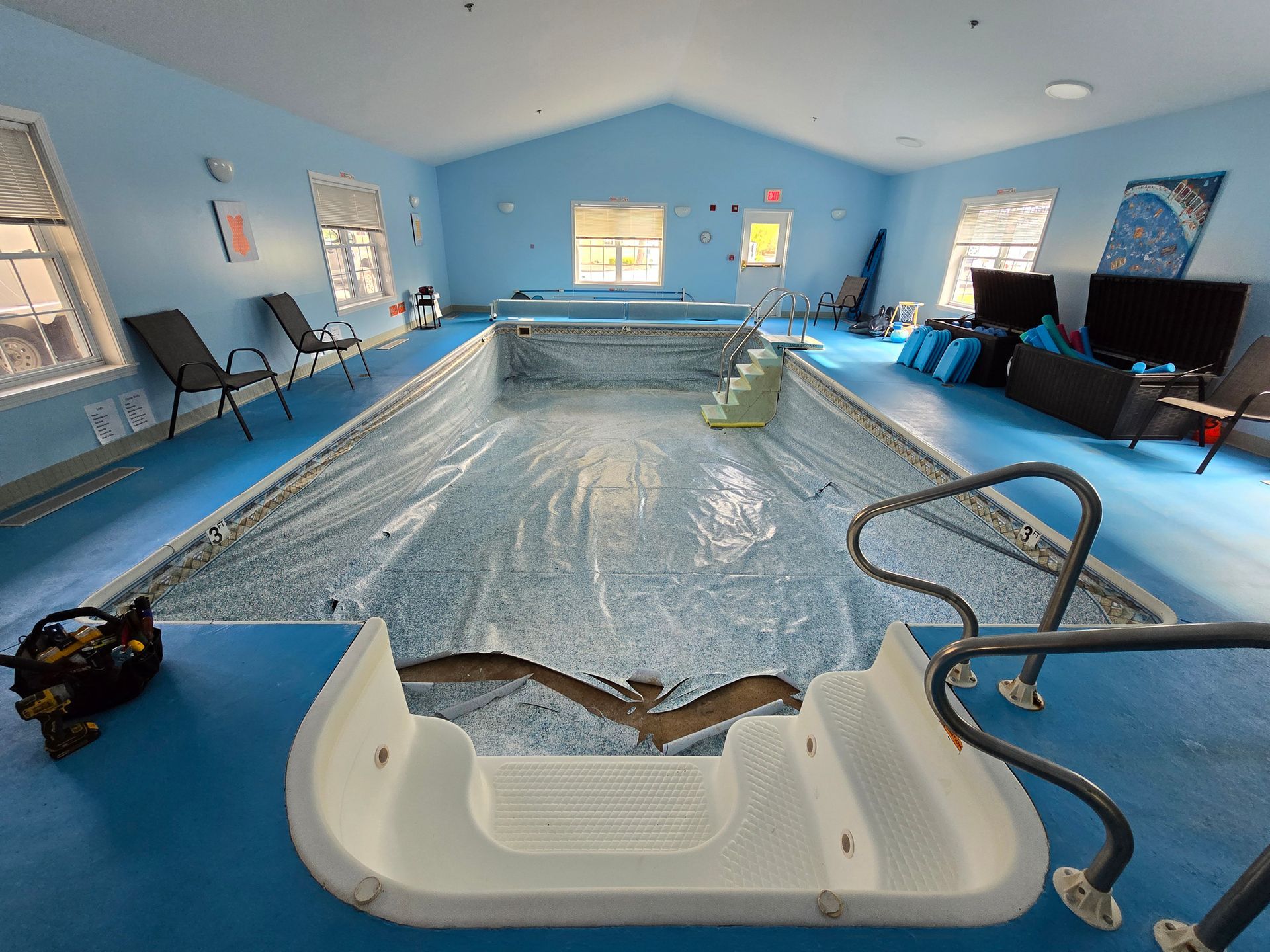 A large indoor swimming pool with stairs leading to it