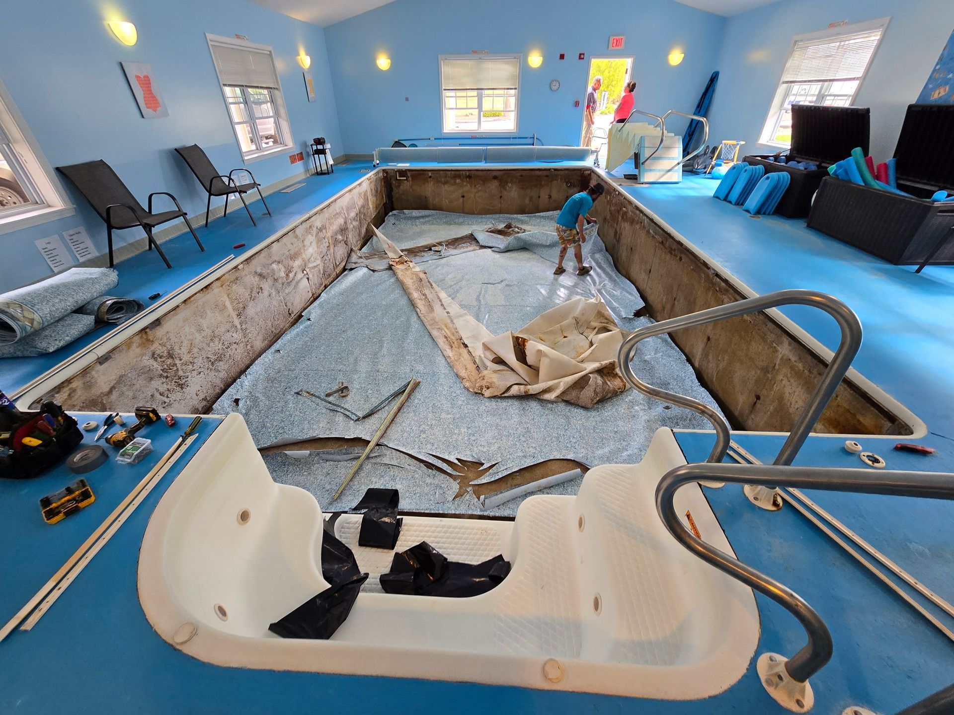 A large swimming pool is being remodeled in a house