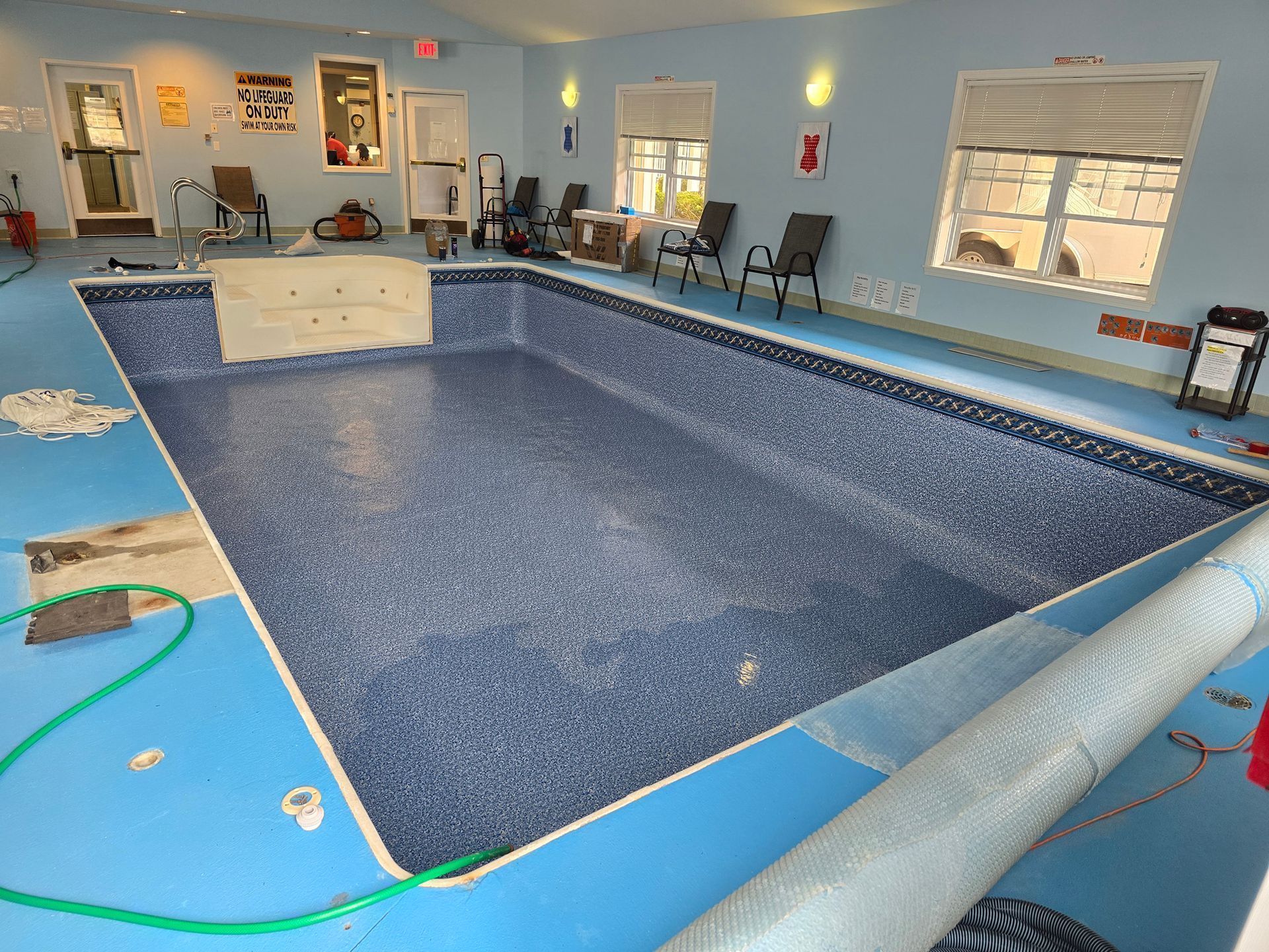 A large indoor swimming pool with blue tiles