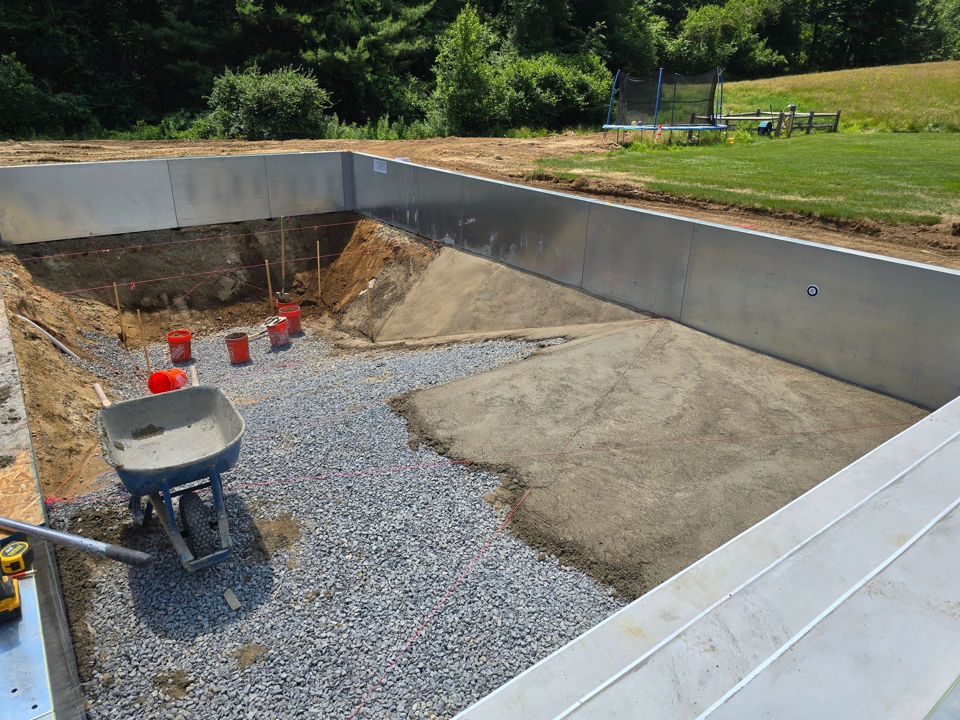 A wheelbarrow is sitting in the middle of a construction site.