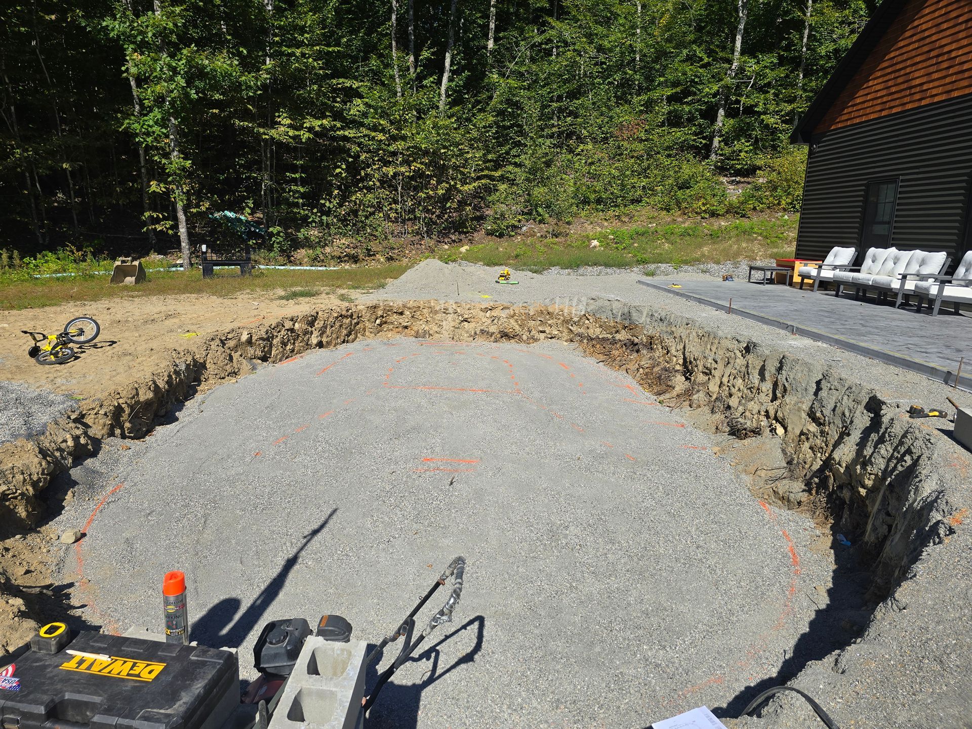 A large hole in the ground with a tractor in the foreground