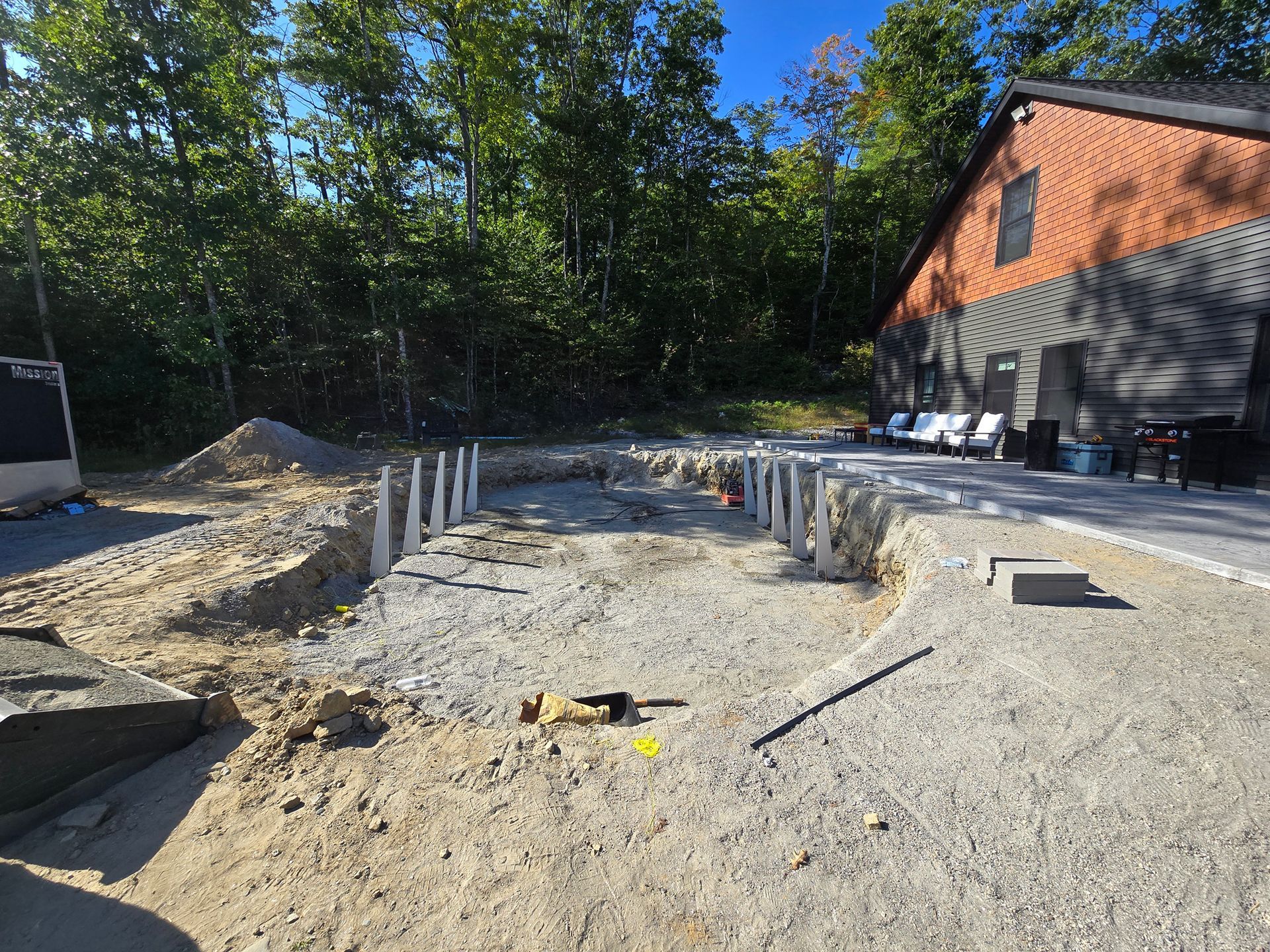 A house is being built in the middle of a dirt field.
