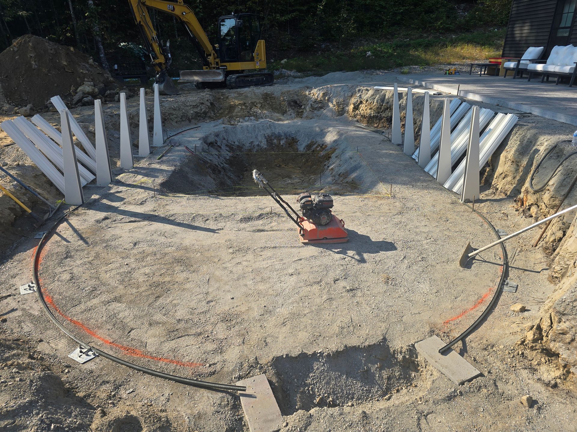 A large hole in the ground is being filled with water.